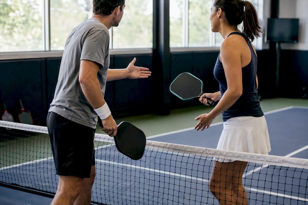 Players disputing line call at pickleball net