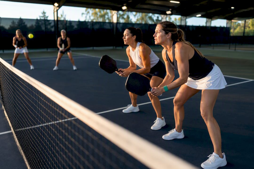 Women playing doubles pickleball at kitchen line