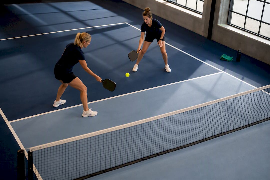 Partners practicing pickleball dinking warmup