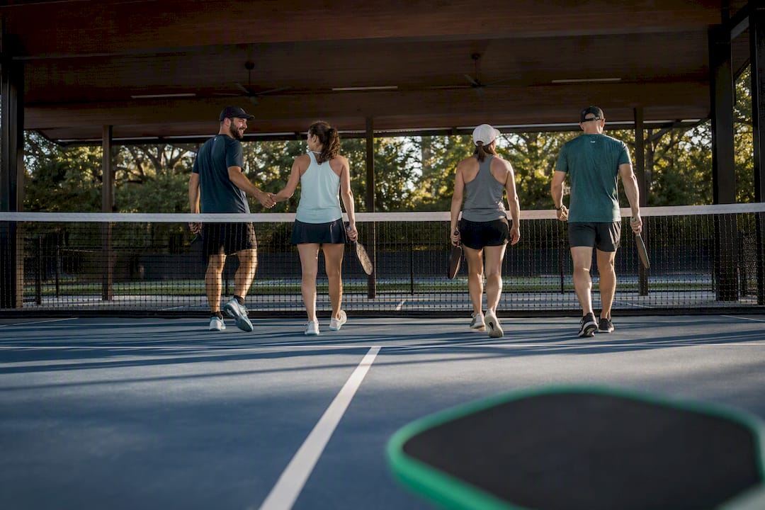 Players changing partners between pickleball rounds