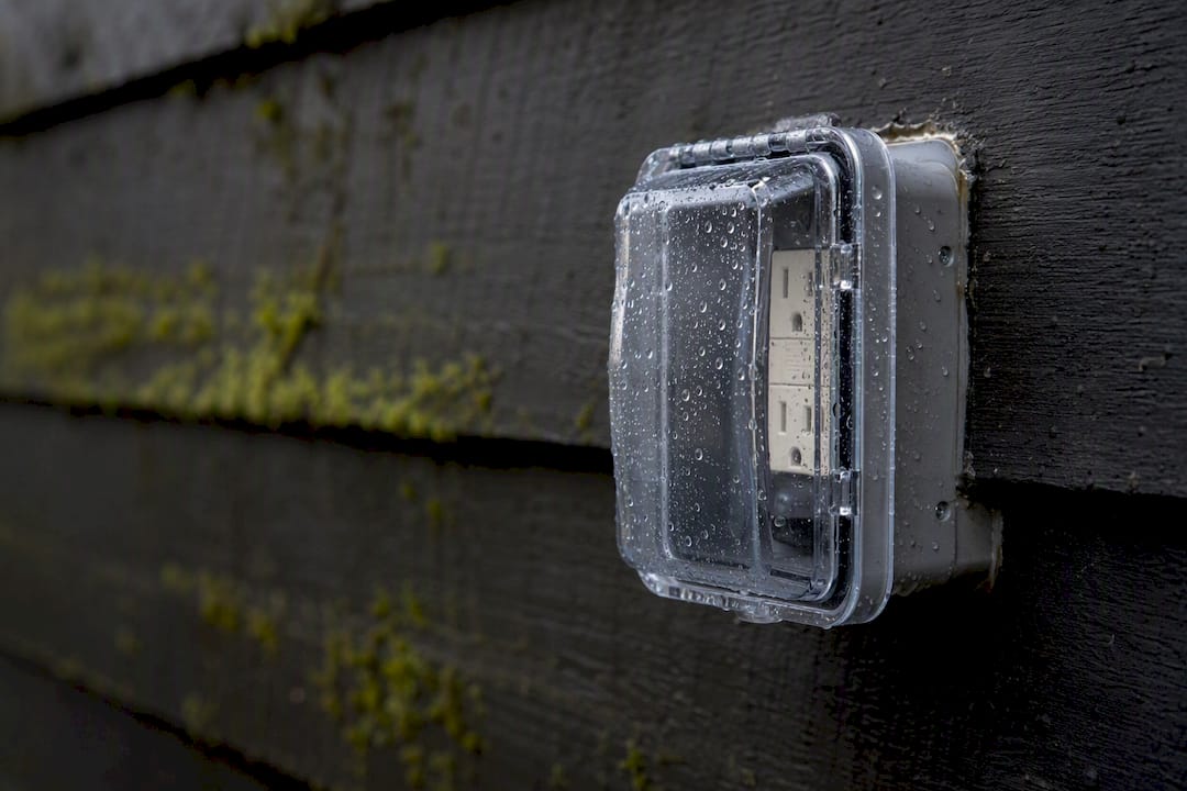 Weatherproof outlet cover protecting outdoor electric outlet