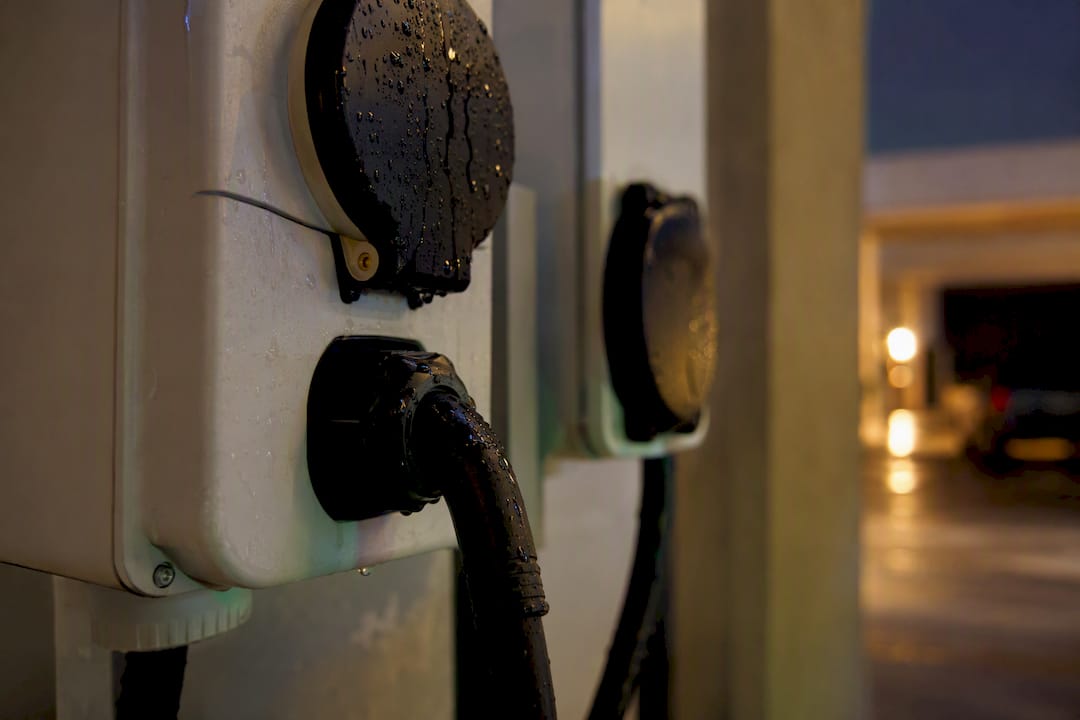 EV charger cable and weatherproof outlet in shared condo parking