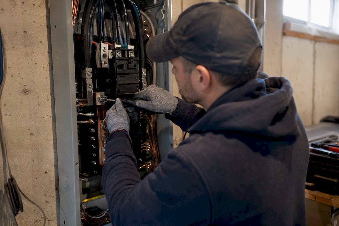 Electrician tightening breaker lug in panel upgrade