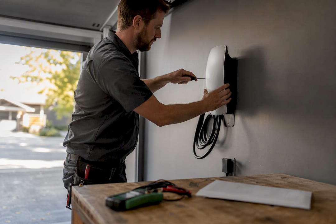 Electrician installing home EV charger