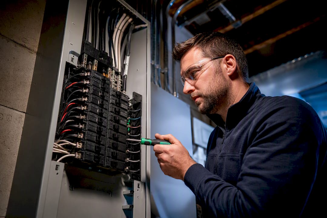Electrician checking residential EV breaker panel