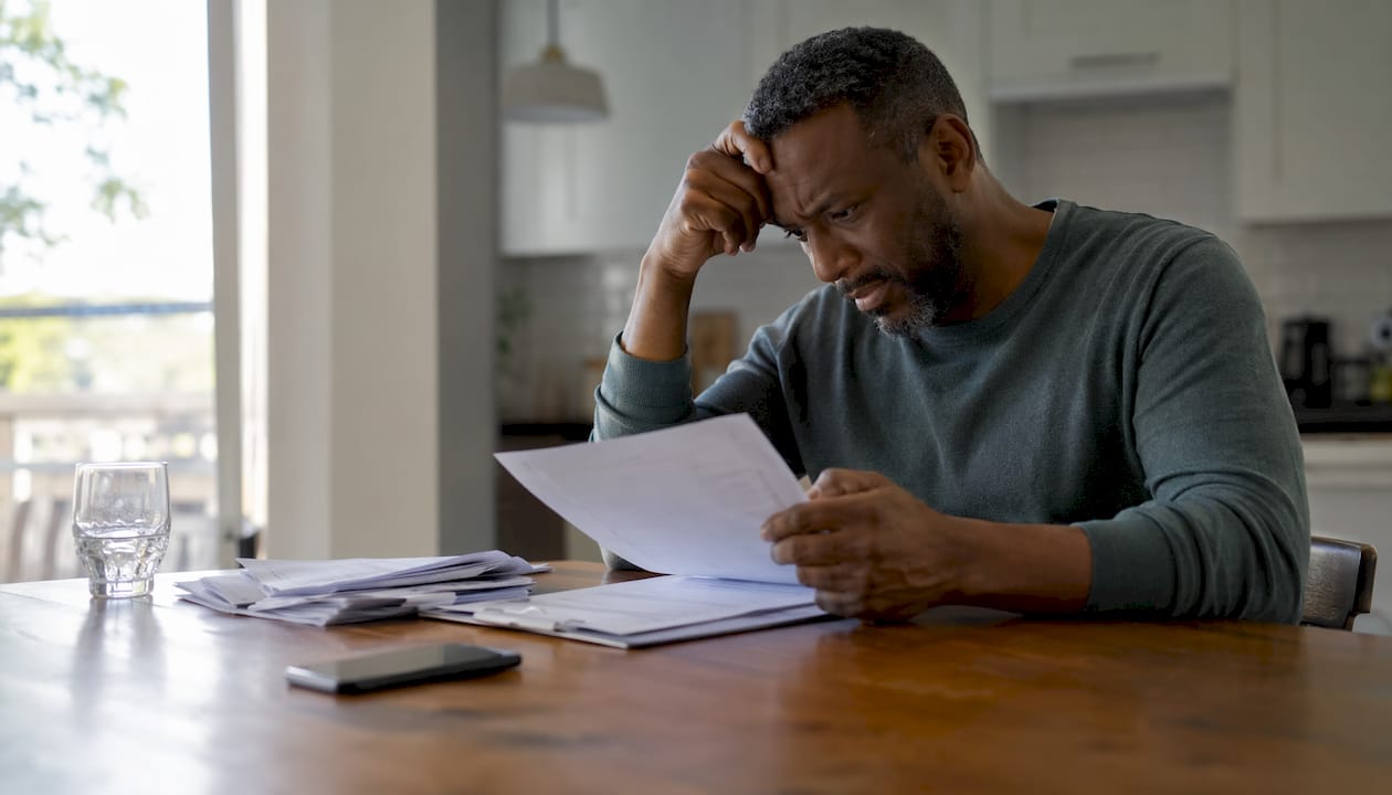 Man reviewing financial documents at desk
