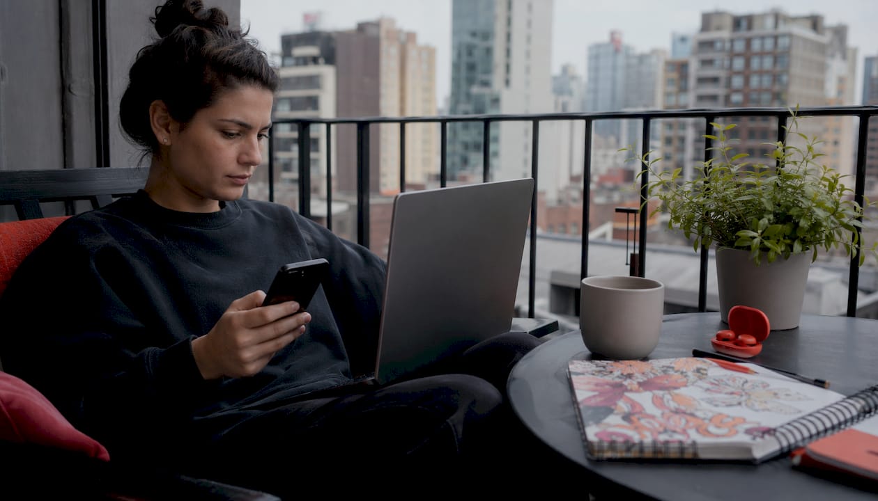 Young woman at kitchen table setting up calendar sync