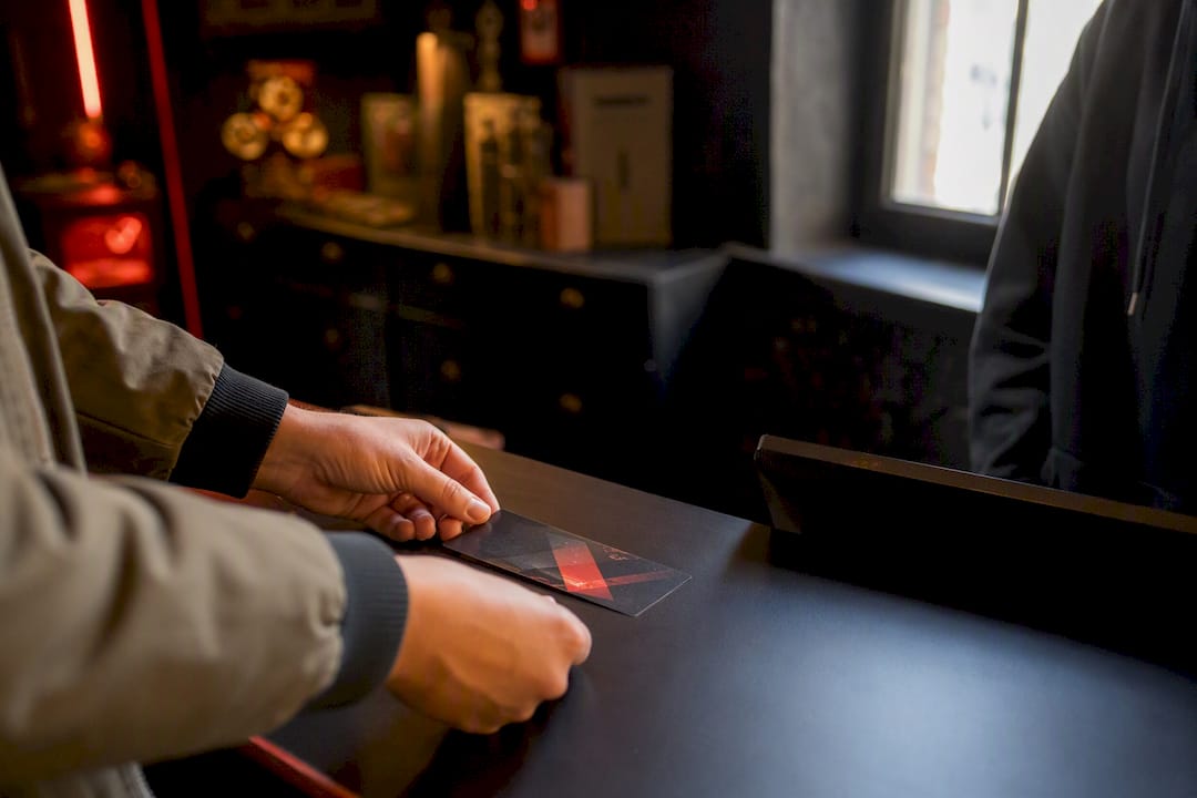 Hands redeeming a gift card at venue counter