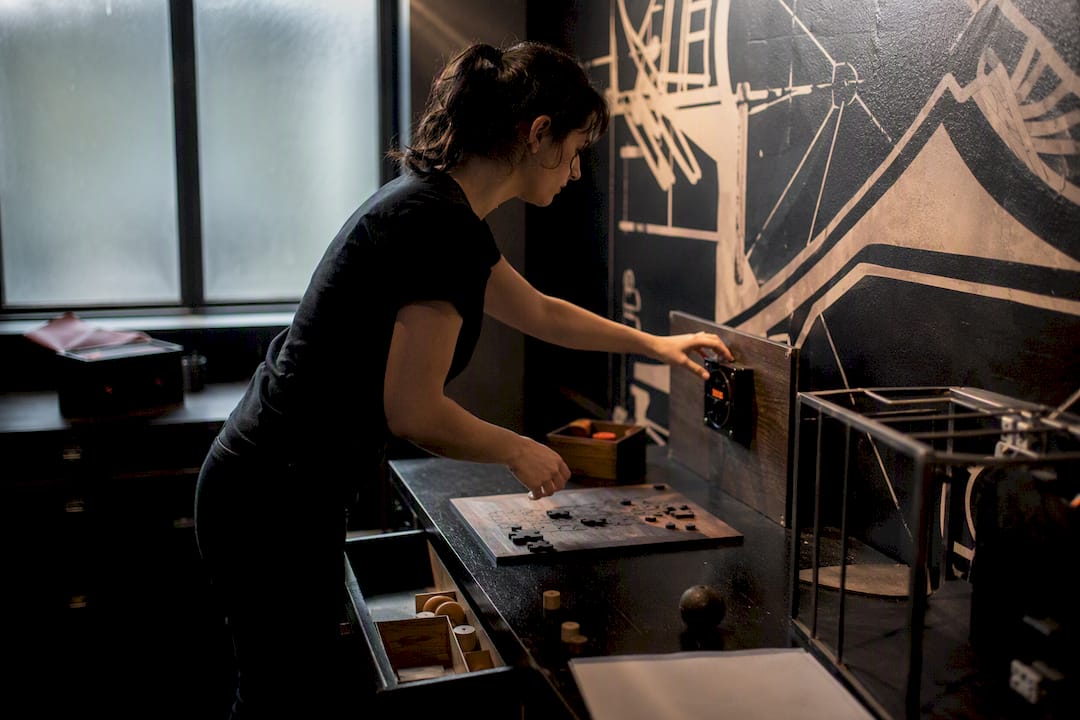 Hands resetting escape room puzzles between games