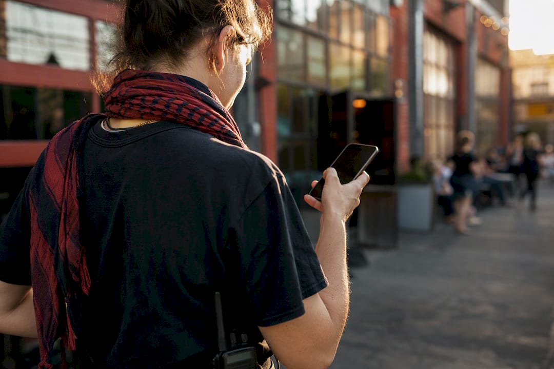 Hand confirming last-minute shift on phone