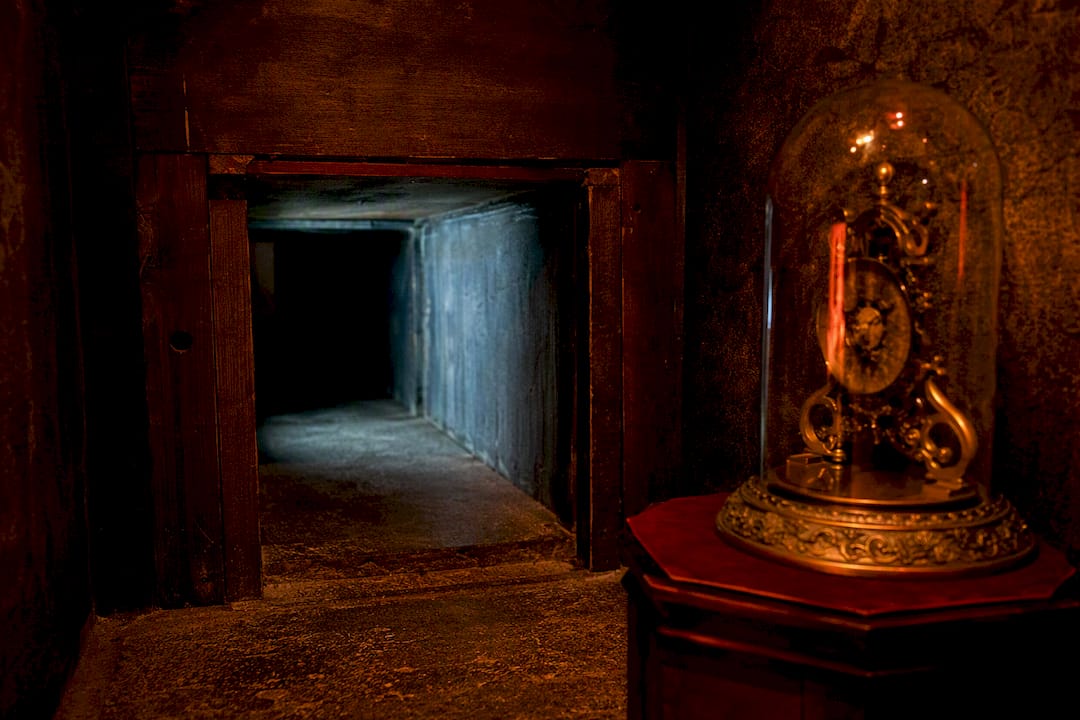 Tight escape room crawl space beside fragile prop