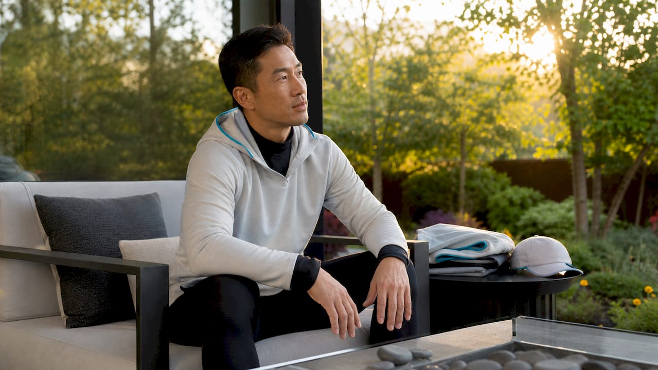 Man sitting showing hoodie layering and hem rise
