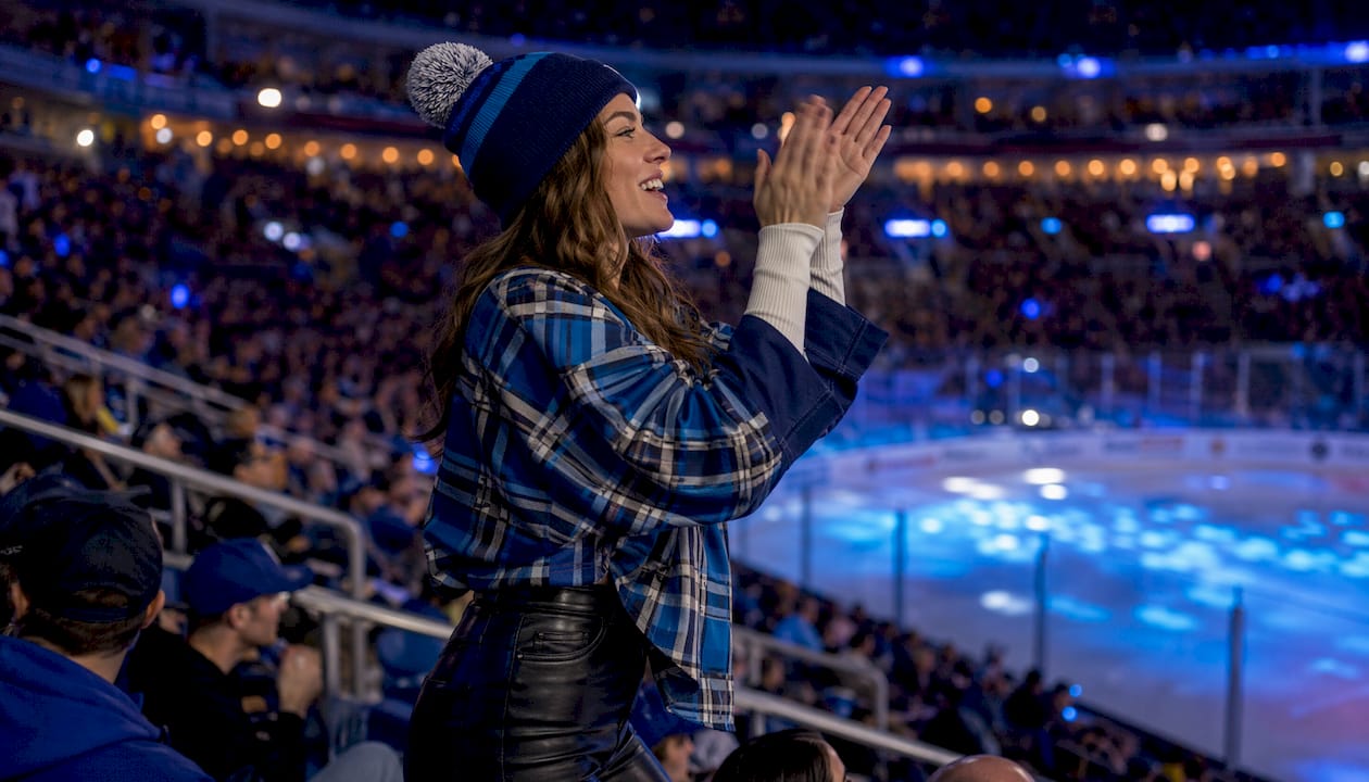 Female fan in hockey jersey showing team spirit