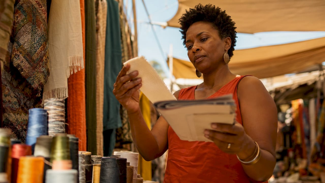 Designer examining cotton fabric swatch