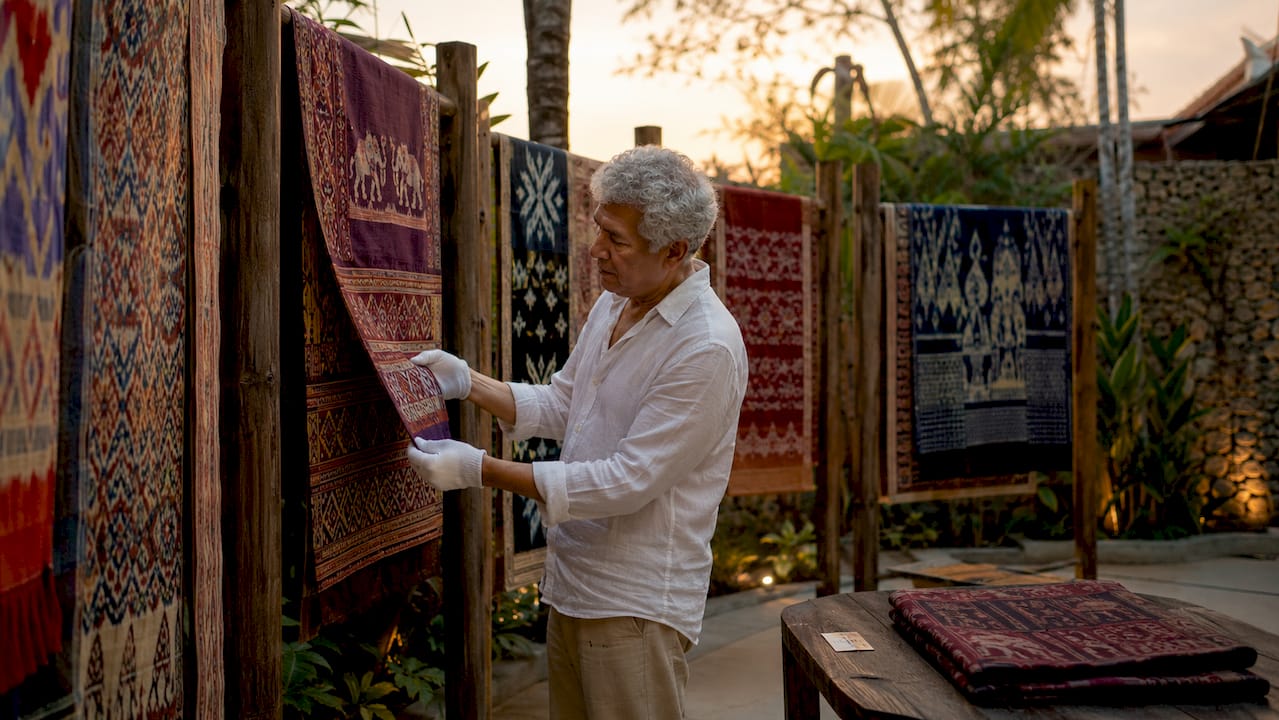 Curator examining historical ikat textiles