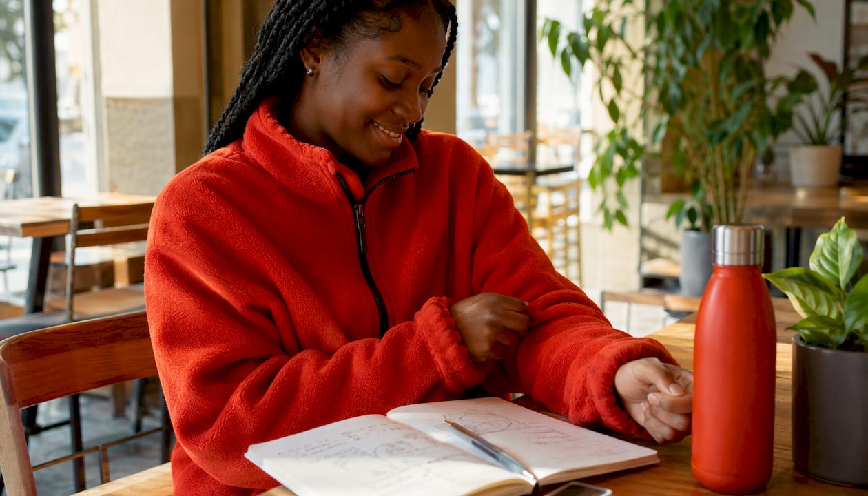 Woman wearing red fleece jacket outdoors