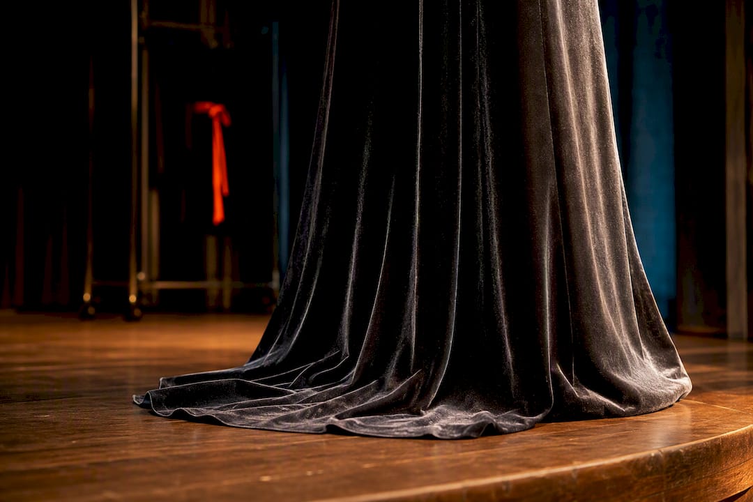 Silk velvet gown hem pooling on stage
