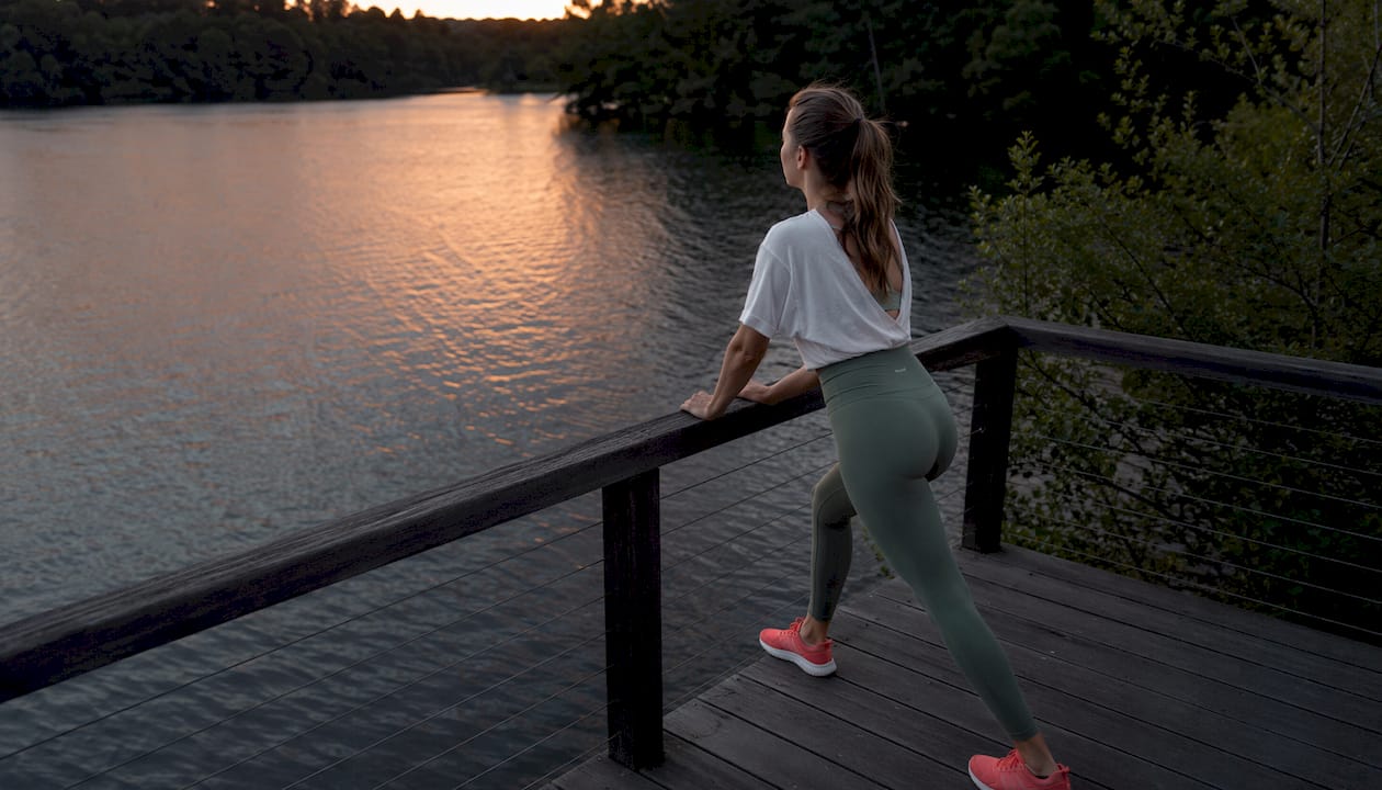 Female runner stretching calf muscles outdoors