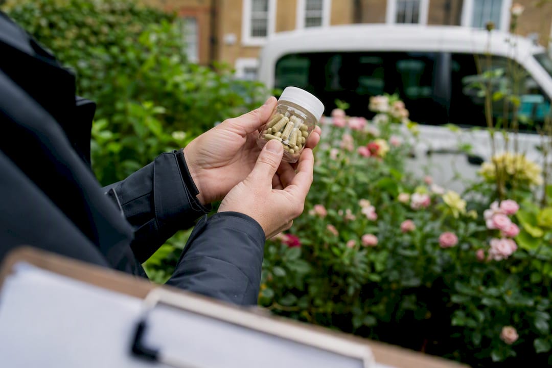 Health inspector holding supplement sample
