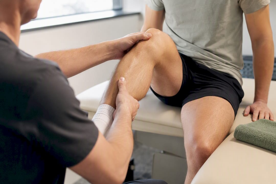 Physiotherapist assessing runner knee movement