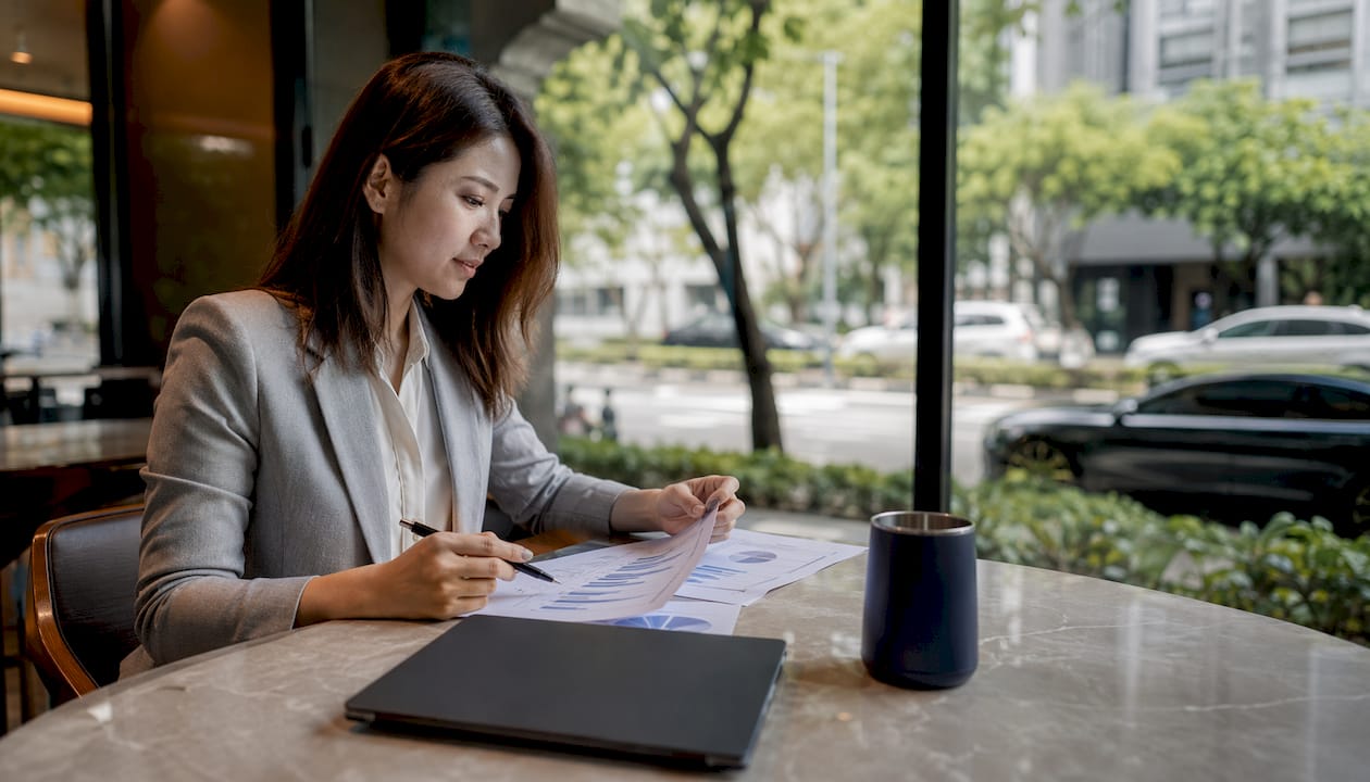 Singapore real estate agent reviewing sales pipeline charts