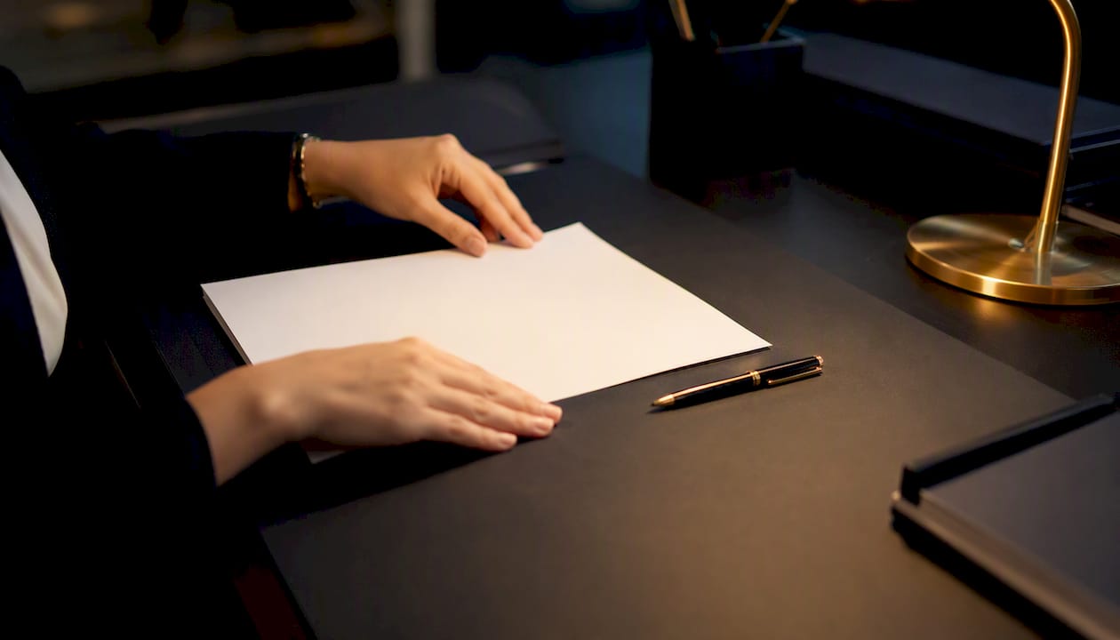 Hands preparing tax invoice for real estate commission