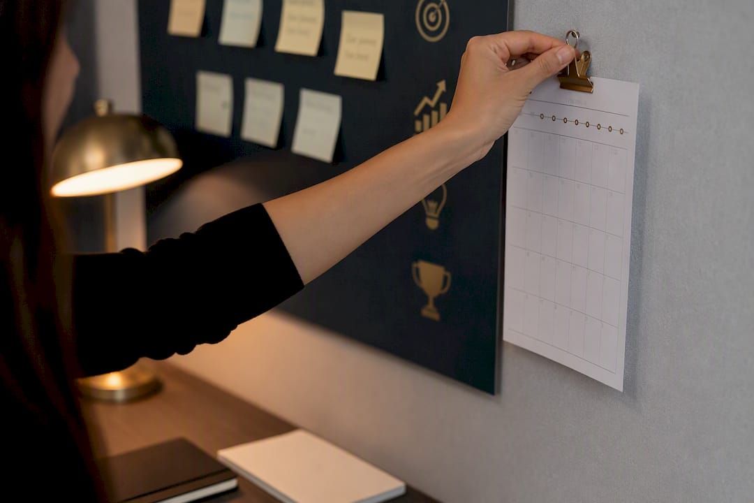 Hand marking career progress on a tracking board