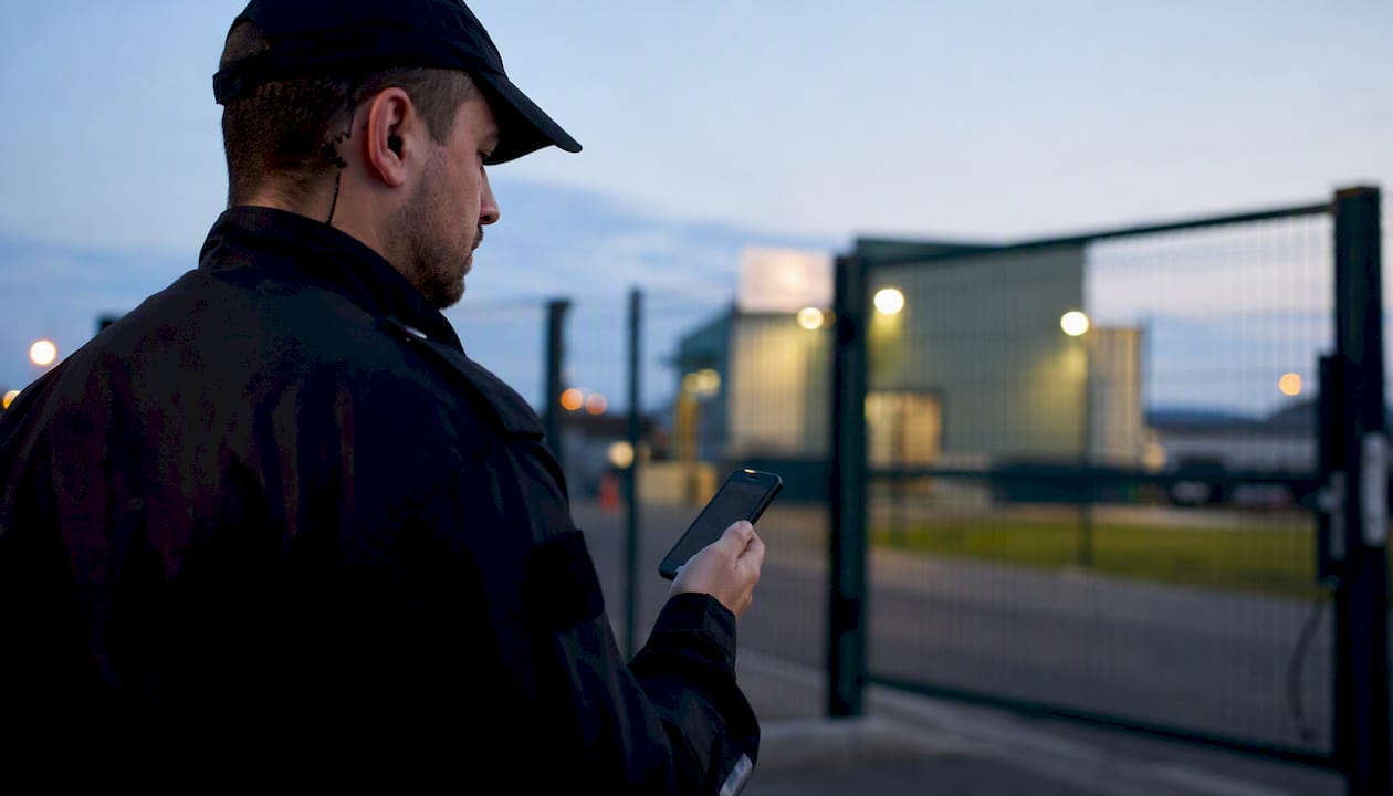 Der Sicherheitsmitarbeiter meldet sich draußen per mobiler Stechuhr an.
