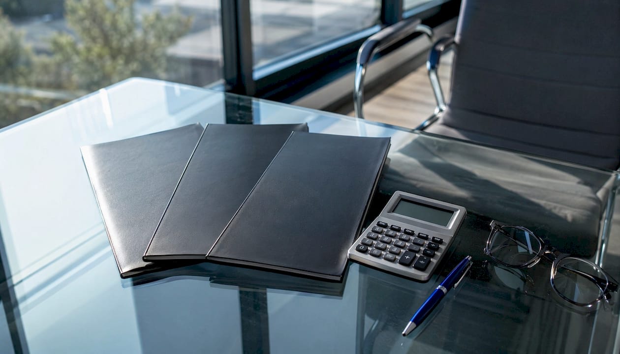 Calculator and papers comparing website costs