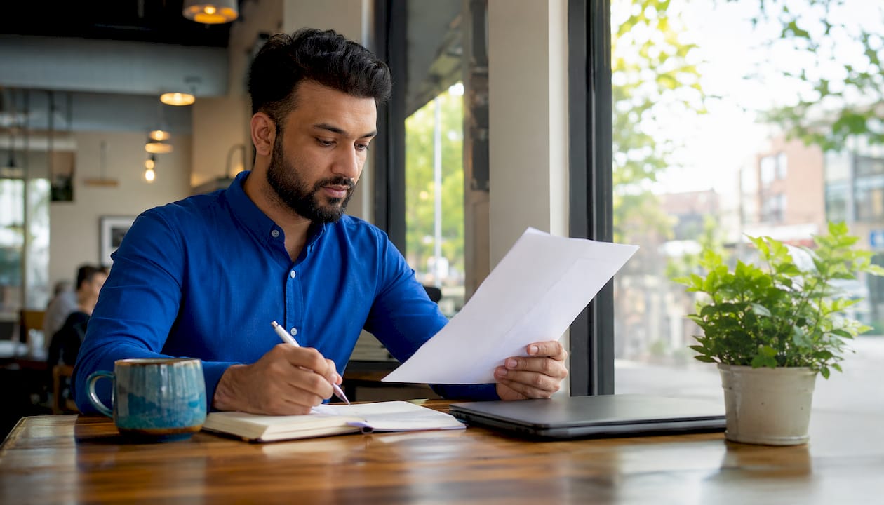 Man comparing Shopify and WooCommerce in home office