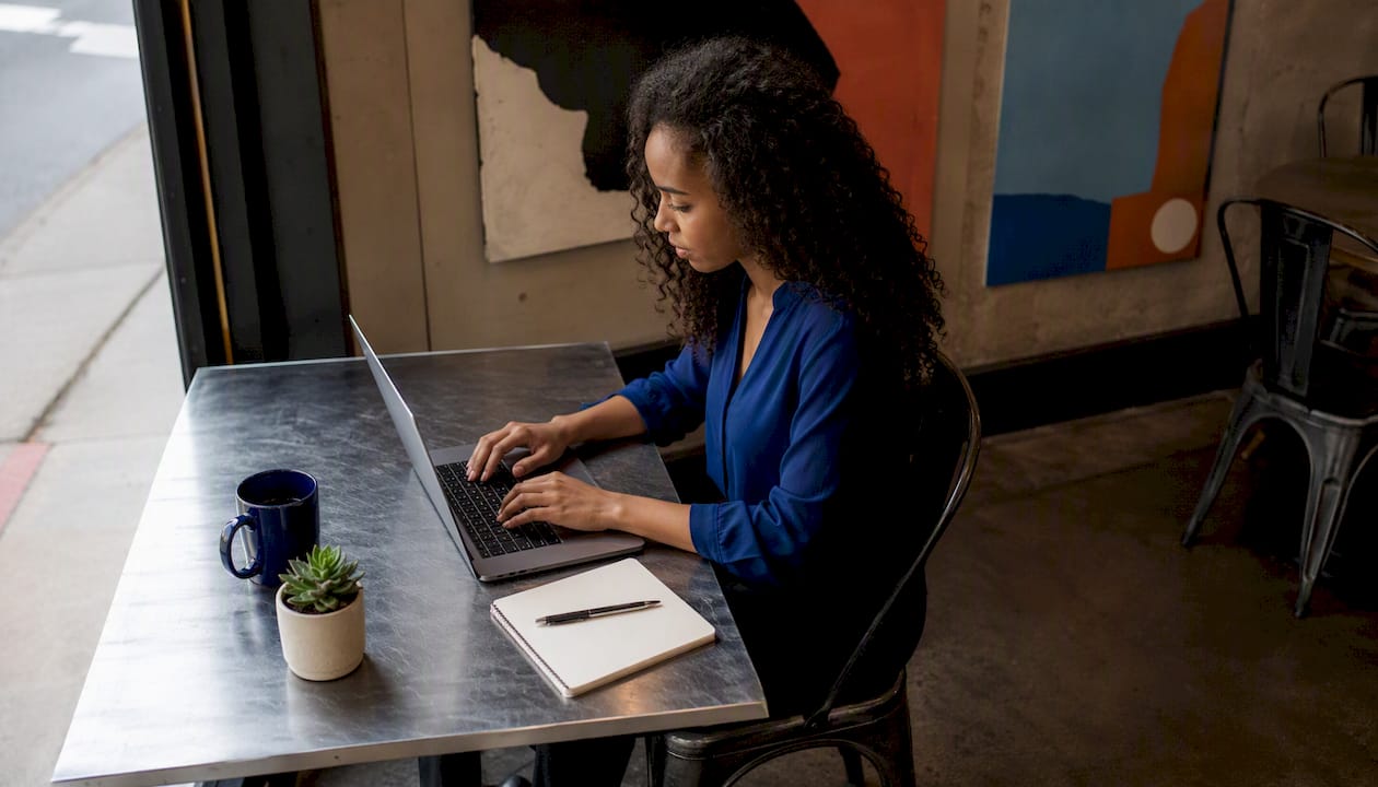 Woman comparing email marketing platforms at home office