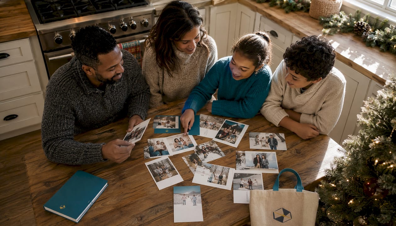 Family arranging personalized holiday photo note cards