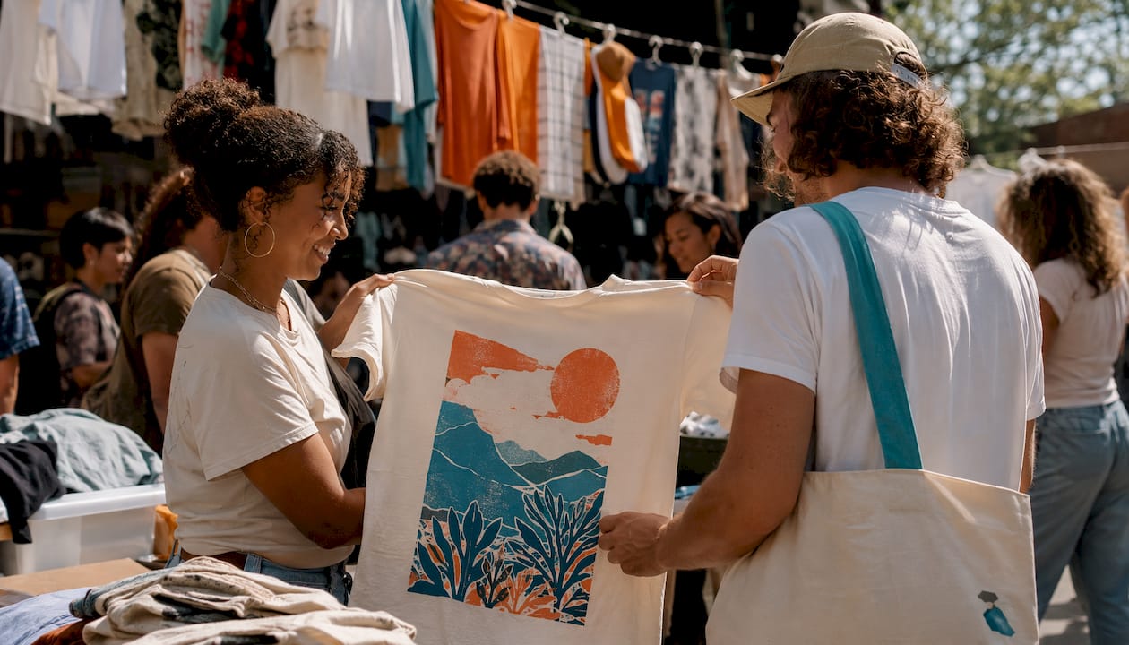 Hands holding screen printed custom t-shirts
