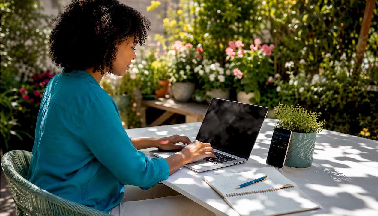 Hands typing digital graduation invitation on laptop