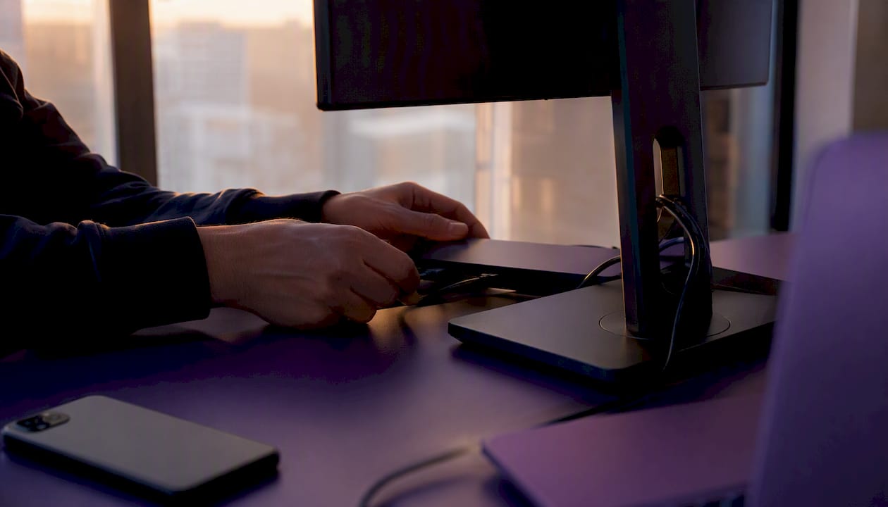 Hands configuring tech workstation