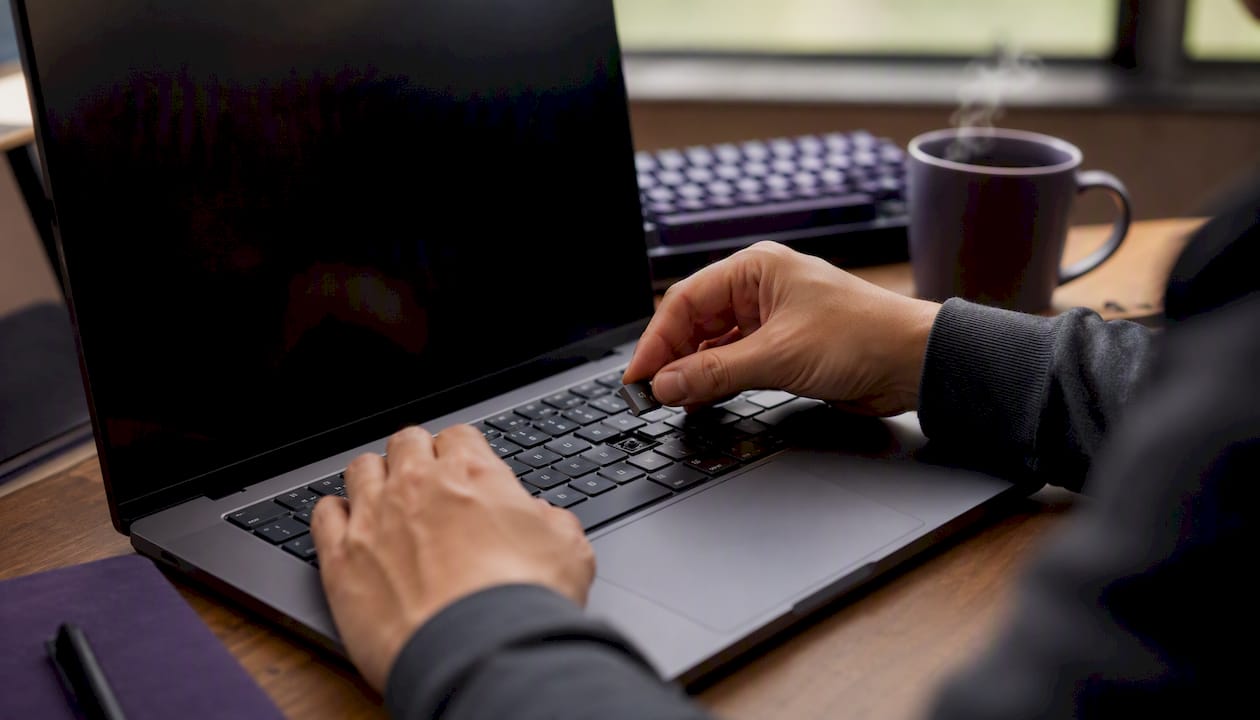 Developer hands replacing API key on laptop