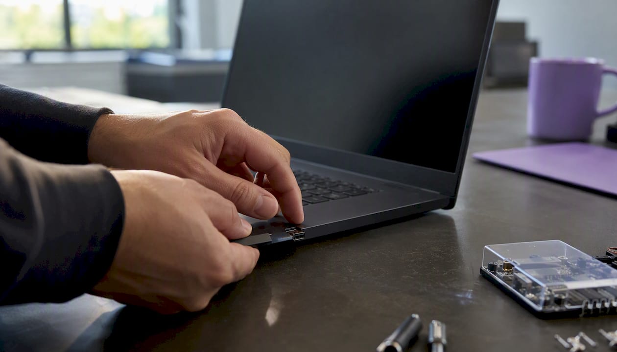 Hands connecting USB security token to laptop