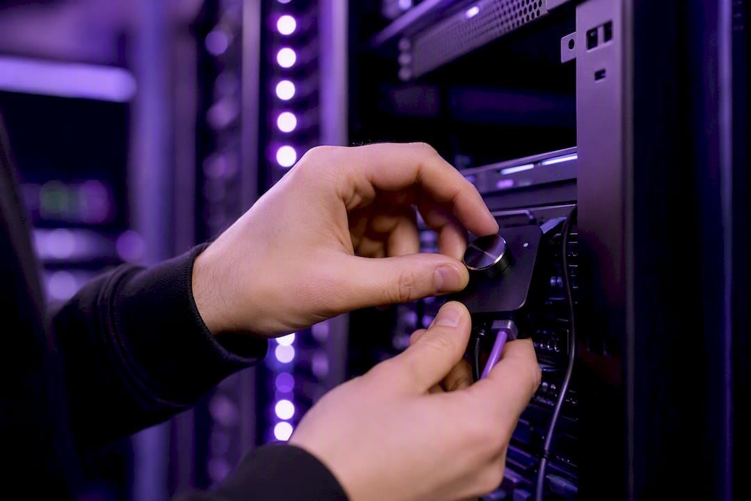 Hands adjusting hardware token in server room