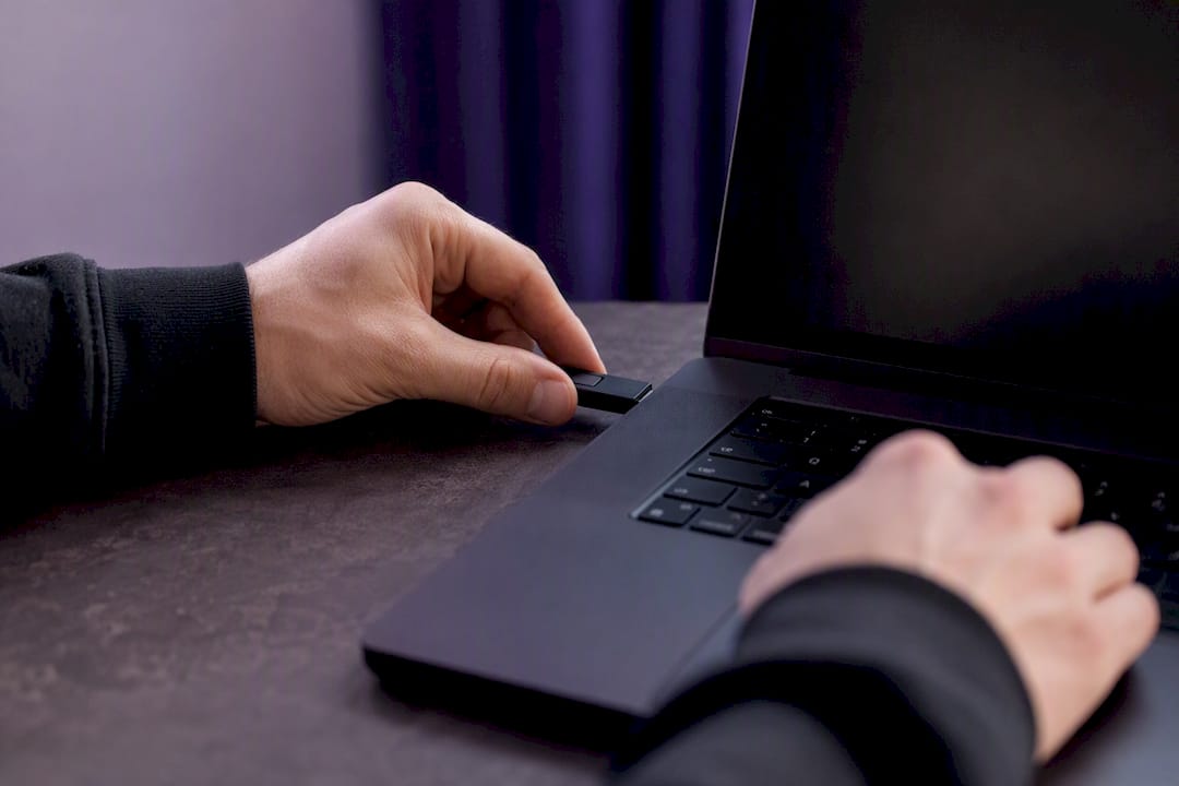 Hands inserting hardware security token