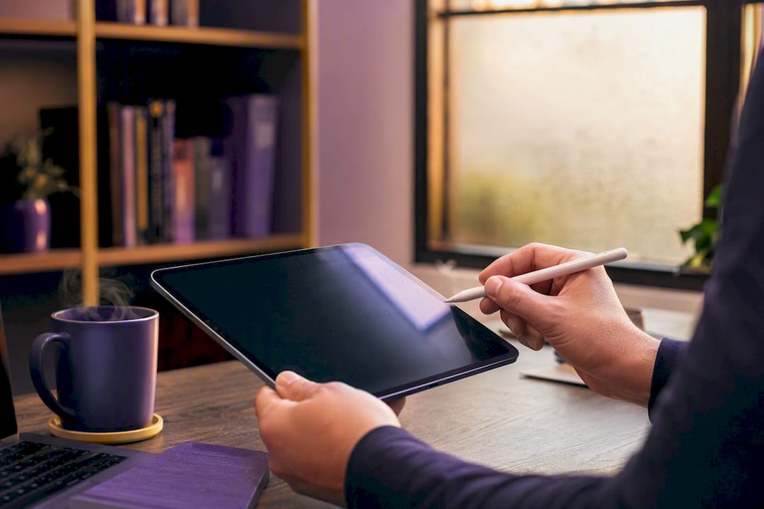 Hands writing JSON version field on tablet