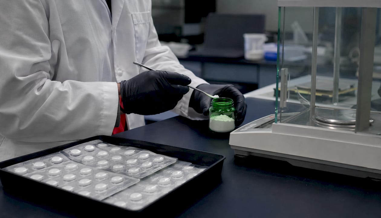 Close-up of tablets and powder formats on lab desk