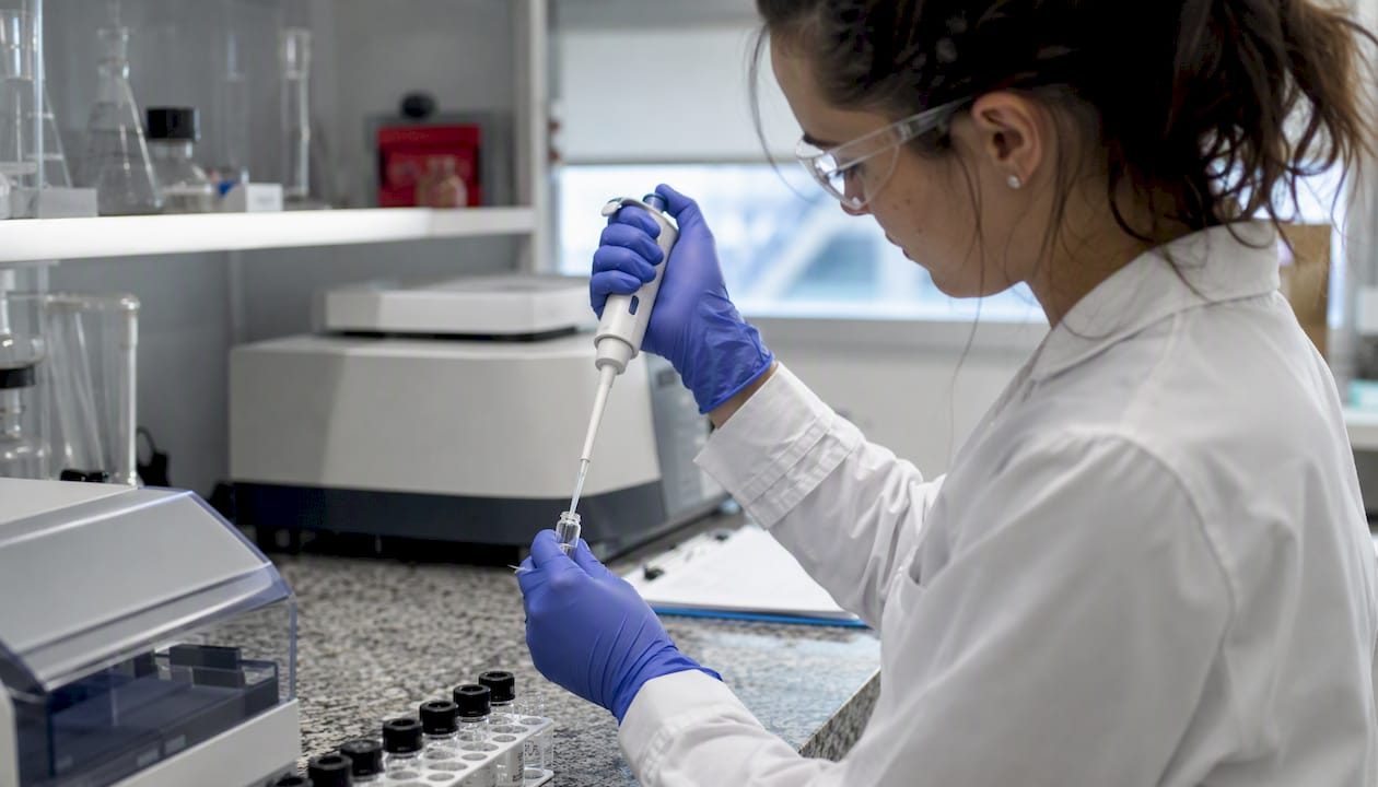 Lab technician pipetting analyte for LOD/LOQ test