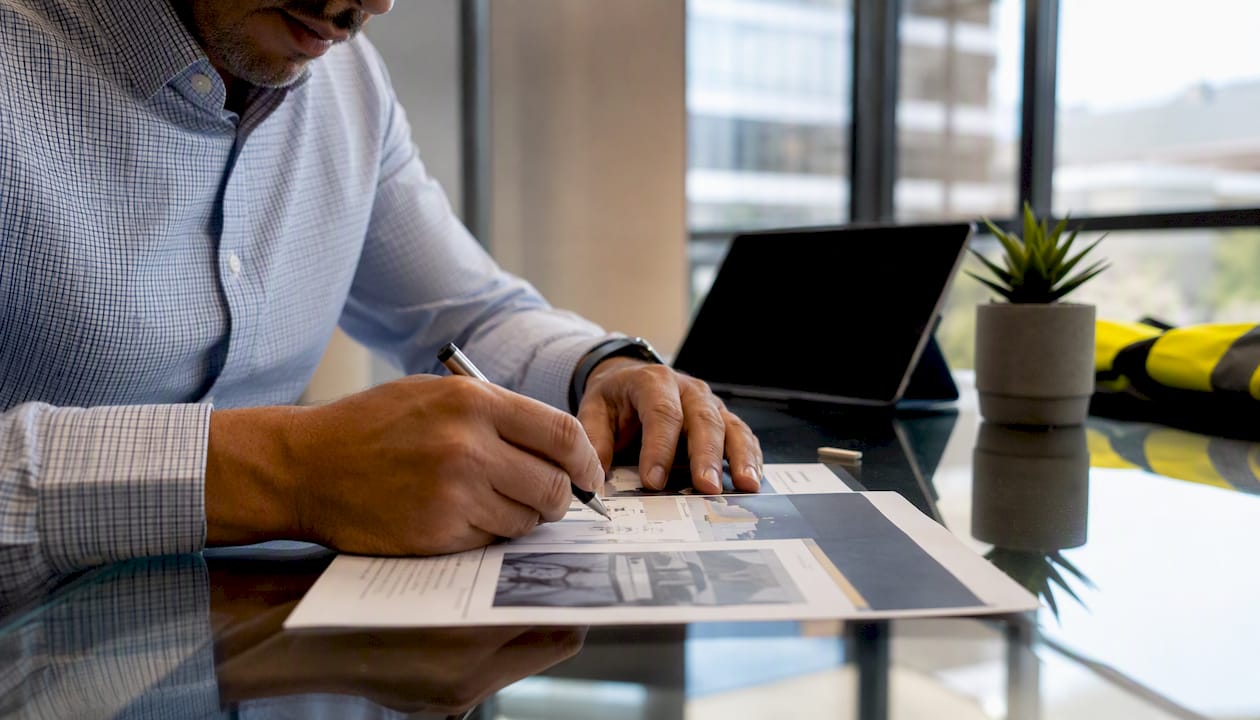 Hands reviewing enterprise EHS platform brochure