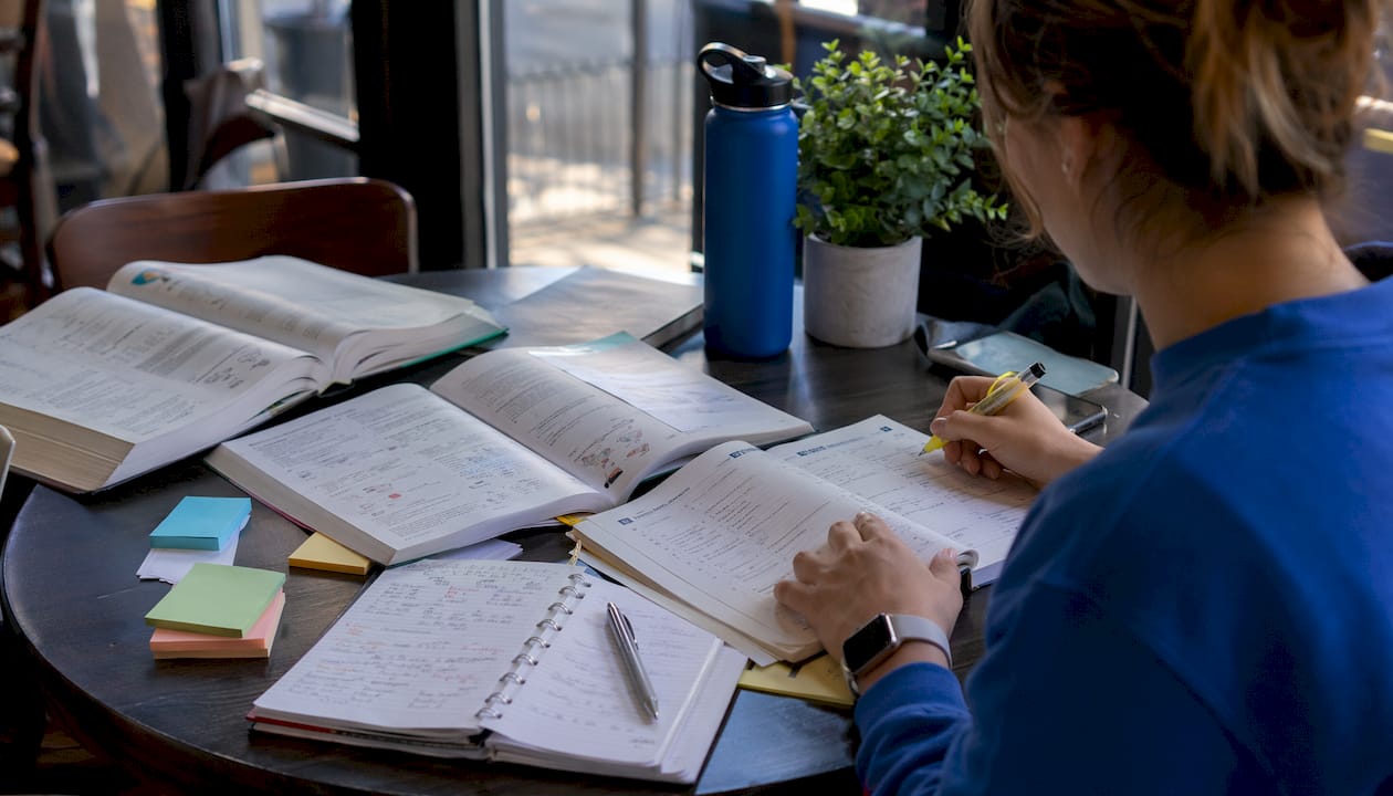 Overhead of hands working on MCAT content review