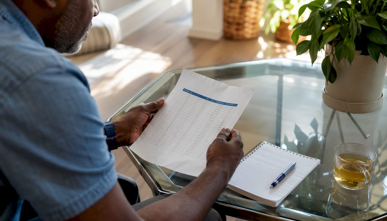 Hands holding income eligibility chart