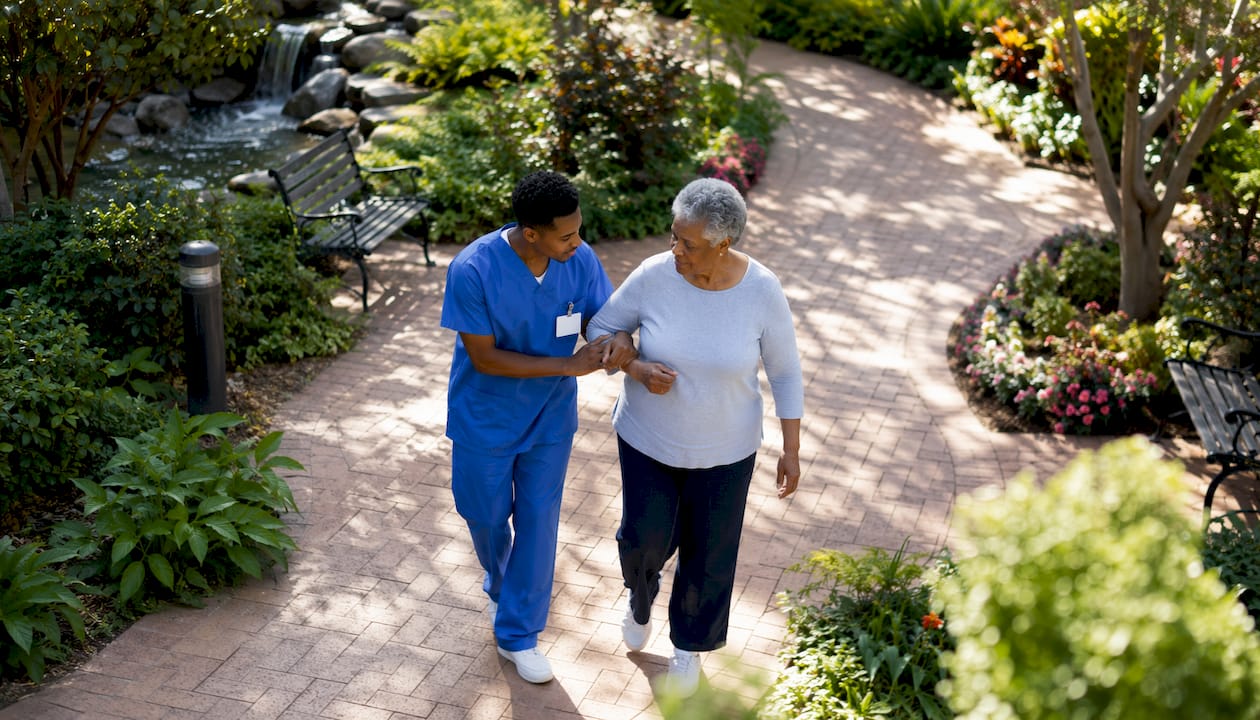 Volunteer assisting patient in hospital waiting room