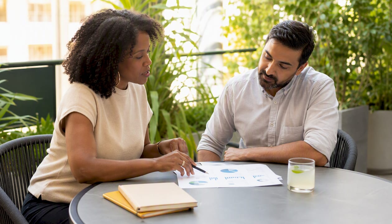 Two colleagues discussing campaign match type strategies in meeting room