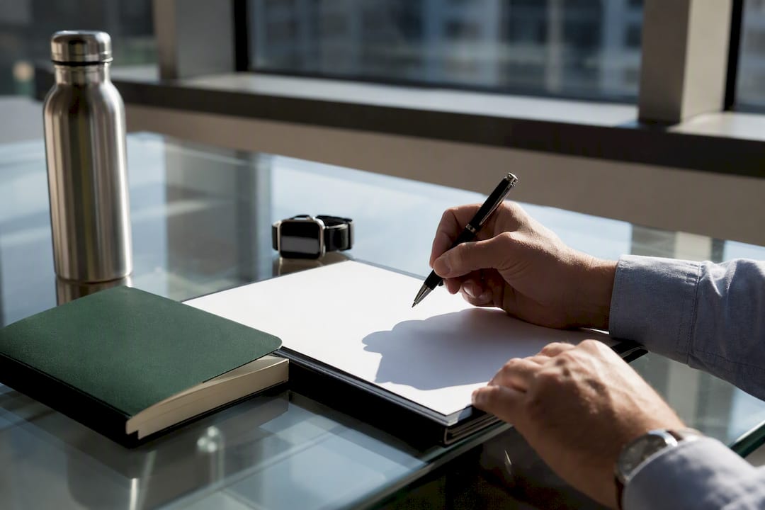 Hands with pen on contract document