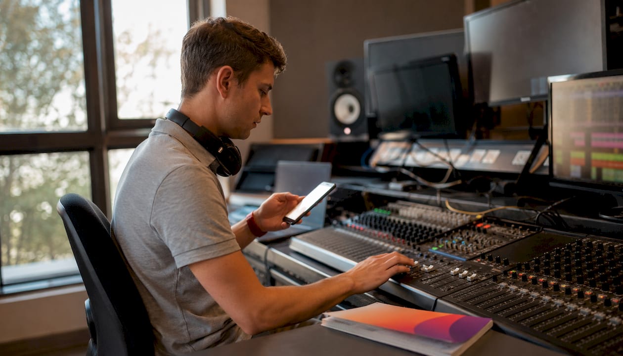 AV technician managing captioning equipment in control room