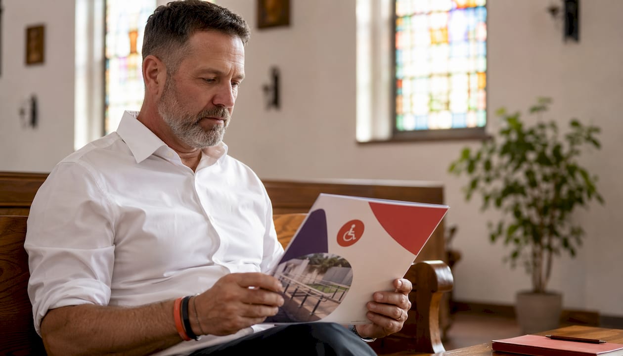 Pastor reviewing ADA compliance brochure